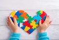 Autism. Making heart of color puzzle pieces Royalty Free Stock Photo