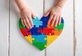 Autism. Making heart of color puzzle pieces Royalty Free Stock Photo