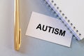 Autism. Word on paper on blue table Royalty Free Stock Photo