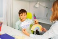 Autistic boy during ABA therapy with weather cards