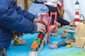 Autistic boy playing with toy car on wooden table Royalty Free Stock Photo