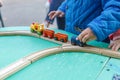 Autistic boy playing with toy car on wooden table Royalty Free Stock Photo