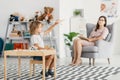 Autistic boy playing with toy during meeting with psychotherapist Royalty Free Stock Photo