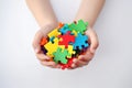 Autistic Pride Day A child holding a colorful puzzle piece in their hands AI generation