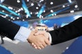 Auto business, car sale, deal, gesture and people concept - Close up of male handshake in auto show or salon. Royalty Free Stock Photo