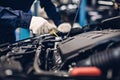 Auto car repair service center. Mechanic checking engine oil level Royalty Free Stock Photo