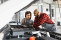 Auto car repair service center. Mechanic examining car engine. Female Mechanic working in her workshop. Auto Service Business Royalty Free Stock Photo