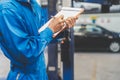 Auto check up and car service shop . Mechanic writing job checklist to clipboard to estimate repair quotation to client at Royalty Free Stock Photo