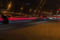 Auto, city street lights and speed. Abstract blurred colorful background of urban street night traffic with bokeh lights Royalty Free Stock Photo