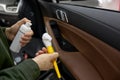 Auto dateline service worker using professional cosmetics for car cleaning