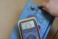 Auto electrician checks the charge quality of an auto battery