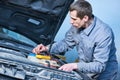Auto electrician mechanic at work with car