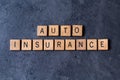 `Auto Insurance` spelled out in wooden letter tiles