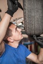 Auto master mechanic checks condition of the brakes and wheels