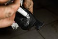 Auto mechanic applying brake grease on backplate of the brake pads. Royalty Free Stock Photo