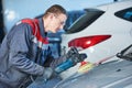 Auto mechanic buffing car autobody