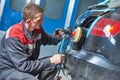 Auto mechanic buffing car autobody