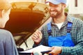 Auto mechanic and car owner signing contract Royalty Free Stock Photo