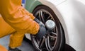 Auto mechanic changing car wheel in garage Royalty Free Stock Photo