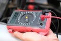 auto mechanic check car battery voltage by voltmeter multimeter Royalty Free Stock Photo