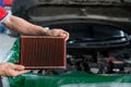 Auto mechanic is checking the engine filter in Car repair station