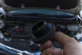 Auto mechanic checking engine oil dipstick in car with oil cap . Auto mechanic in car repair Royalty Free Stock Photo