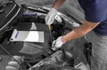 Auto mechanic checking the oil level in car engine Royalty Free Stock Photo