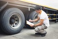 Auto Mechanic is Checking the Truck`s Safety Maintenance Checklist. Inspection Truck Safety of Semi Truck Wheels Tires Royalty Free Stock Photo