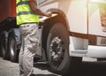 Auto Mechanic is Checking the Truck`s Safety Maintenance Checklist. Lorry Fixing. Truck Inspection Safety Semi Truck Wheels Tires. Royalty Free Stock Photo