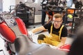 Auto mechanic checks technical condition of motorcycle in workshop