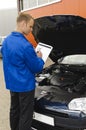 Auto mechanic checks a vehicle Royalty Free Stock Photo