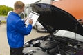 Auto mechanic checks a vehicle Royalty Free Stock Photo