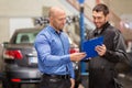 Auto mechanic and customer at car shop Royalty Free Stock Photo