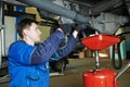 Auto mechanic disassembling axle Royalty Free Stock Photo