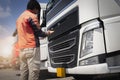 Auto Mechanic Driver holding Clipboard Checking Maintenance and Safety Program of Semi Truck. Royalty Free Stock Photo