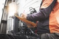 Auto Mechanic Driver Holding Clipboard is Checking Maintenance and Safety Program of Semi Truck Royalty Free Stock Photo