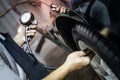 Auto mechanic hand checking tire pressure Royalty Free Stock Photo