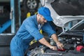 Auto mechanic hands using wrench to repair a car engine. Auto mechanic man automotive diagnostic Checking car service, repair, Royalty Free Stock Photo