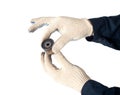 An auto mechanic holds and checks the timing belt idler on a white background, isolate. Faulty timing roller, industry