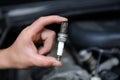 Auto mechanic holds an spark plug Royalty Free Stock Photo