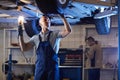 Auto Mechanic Inspecting Car on Lift Royalty Free Stock Photo