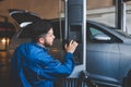 Auto mechanic lifts a car on a lift. Car repair