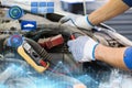 Auto mechanic man with multimeter testing battery Royalty Free Stock Photo