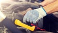 Auto mechanic man with multimeter testing battery Royalty Free Stock Photo