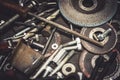 Auto mechanic metal parts and tools on a table. Close up view of finishing equipment, drills, bits, screws, bolts. Royalty Free Stock Photo