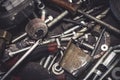 Auto mechanic metal parts and tools on a table. Close up view of finishing equipment, drills, bits, screws, bolts.