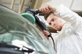 Auto mechanic polishing car Royalty Free Stock Photo