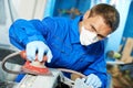 Auto mechanic polishing car Royalty Free Stock Photo