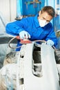 Auto mechanic polishing car Royalty Free Stock Photo