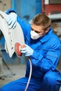 Auto mechanic polishing car body Royalty Free Stock Photo